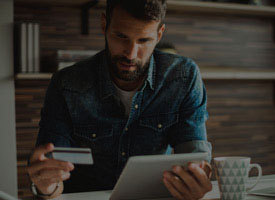 Guy with a credit card looking at an iPad